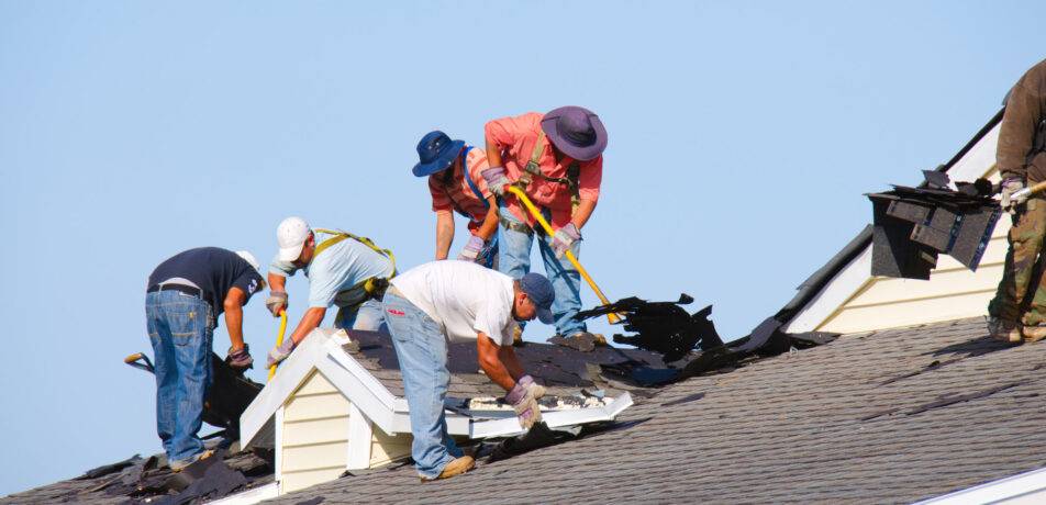 roof replacement experts working on roof