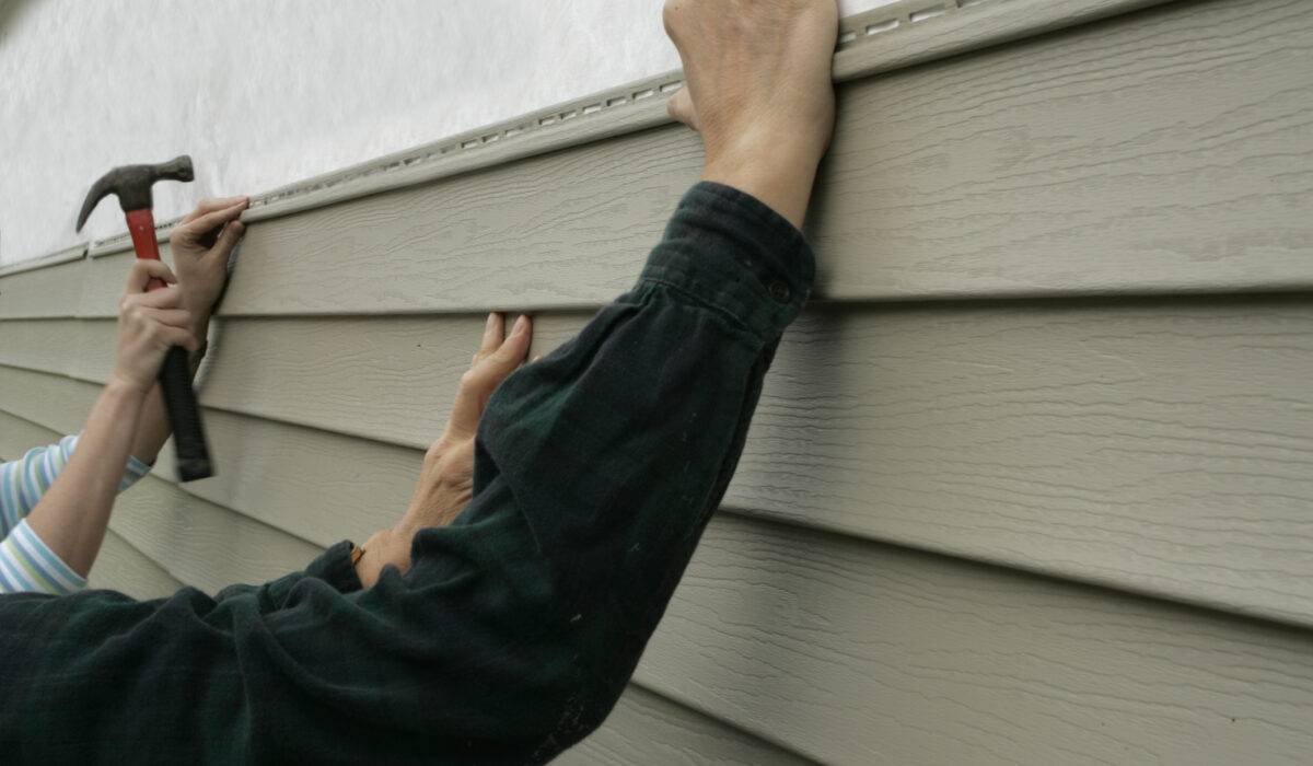 installers working on vinyl siding