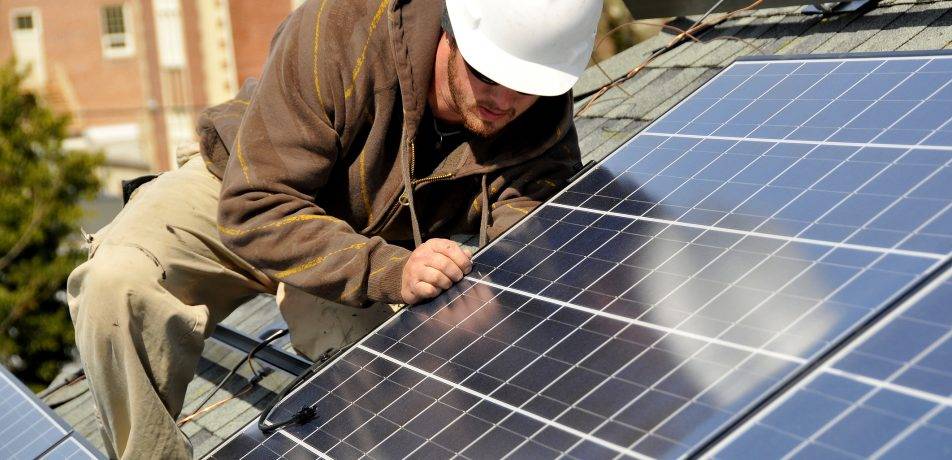 roofer installing solar panels